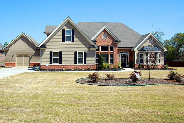 newly mulched flower beds in a yard